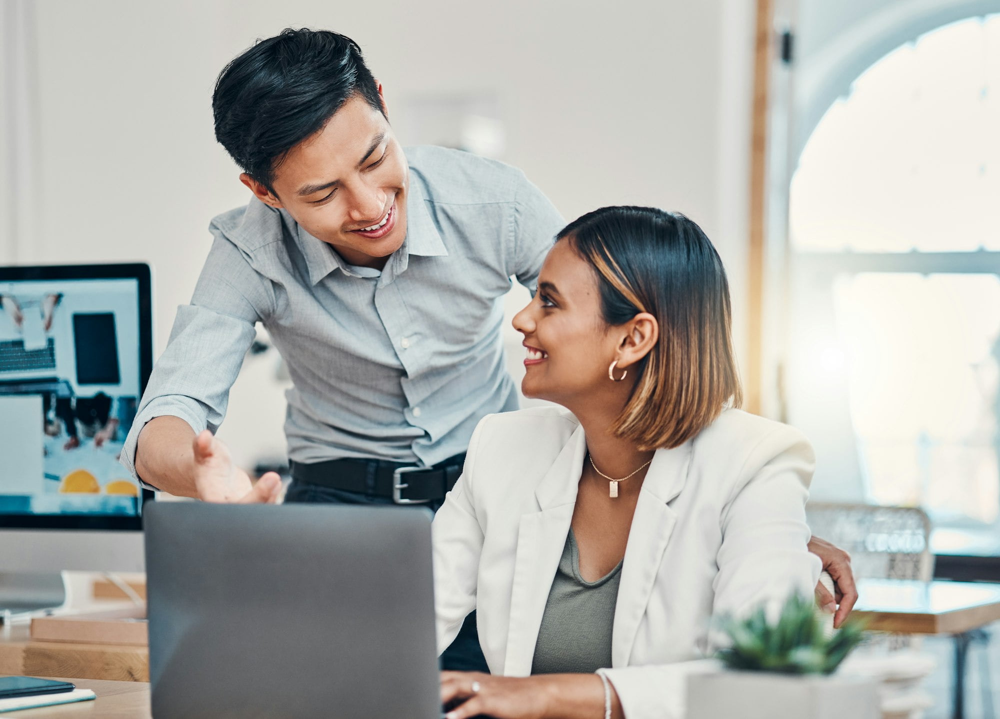 Startup company success, working people at desk and asian manager coaching employee in Singapore of